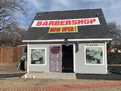Duff's Barber Shop building on opening day with a Barbershop Now Open banner