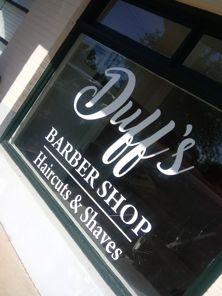 Duff's Barber Shop storefront window lettering: Duff's Barber Shop — Haircuts and Shaves